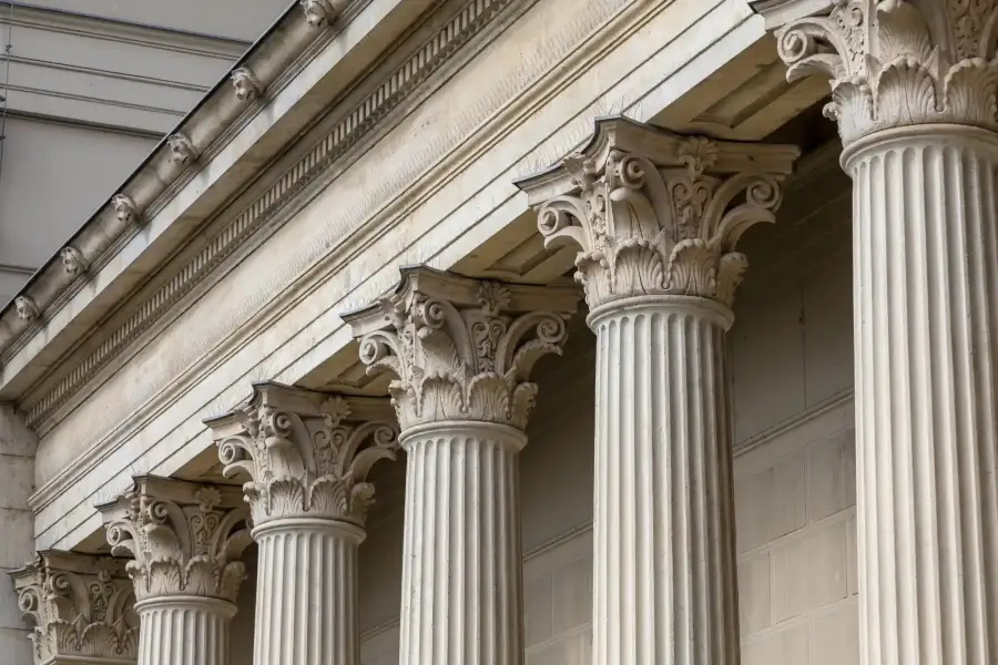 Close-up of six ornate Corinthian columns supporting a classical building facade.